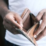 Cash Flow - person holding brown leather bifold wallet