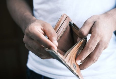 Cash Flow - person holding brown leather bifold wallet