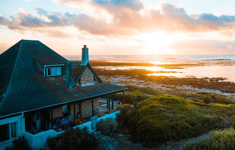 Vacation Home - aerial photo of house near calm body of water