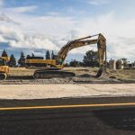 Construction Site - yellow Caterpillar excavator digging up dirt