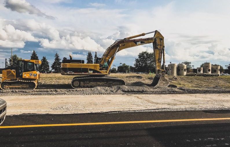 Construction Site - yellow Caterpillar excavator digging up dirt