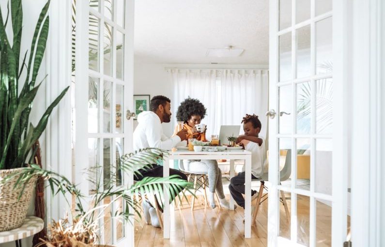 Family Home - people sitting on chairs in front of table