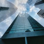Office Buildings - low angle photography of high rise building under white clouds during daytime