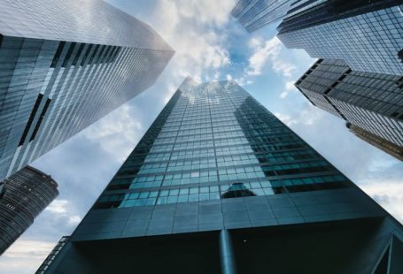 Office Buildings - low angle photography of high rise building under white clouds during daytime