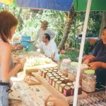 Buyer's Market - woman standing in front of stall