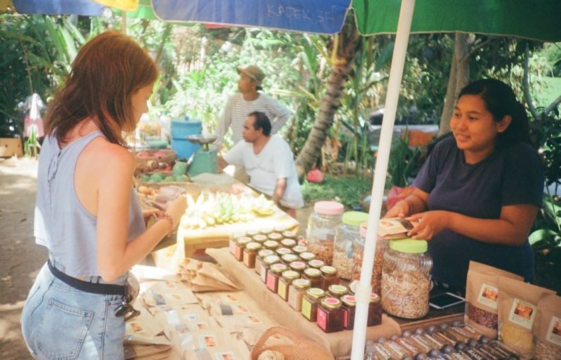 Buyer's Market - woman standing in front of stall
