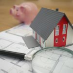 Property Investment - white and red wooden house beside grey framed magnifying glass