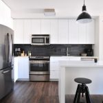 Real Estate Vs. Stocks - gray steel 3-door refrigerator near modular kitchen