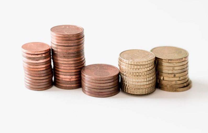 Calculator Finance - stacked round gold-colored coins on white surface