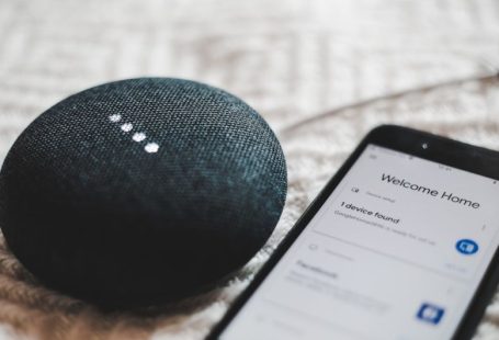 Smart Home - turned-on charcoal Google Home Mini and smartphone