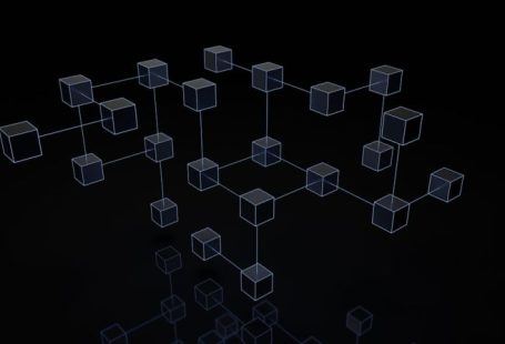 Blockchain Network - a black and white photo of cubes on a black background