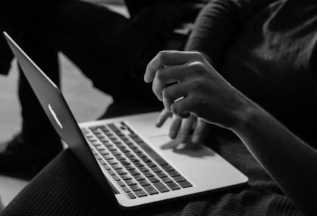 Online Marketplace - grayscale photo of person using MacBook
