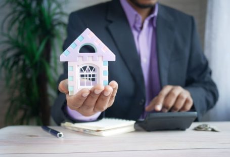 Property Manager - man in purple suit jacket using laptop computer